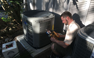 Justin installing an AC unit