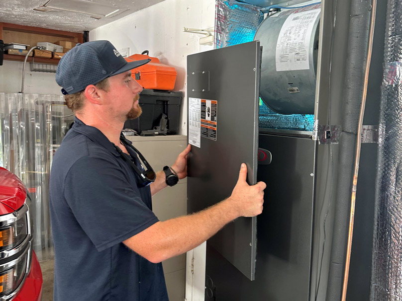 Airtech employee servicing a home hvac system