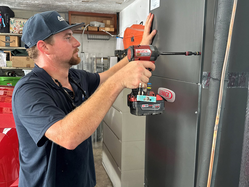 Technician working on a heat pump