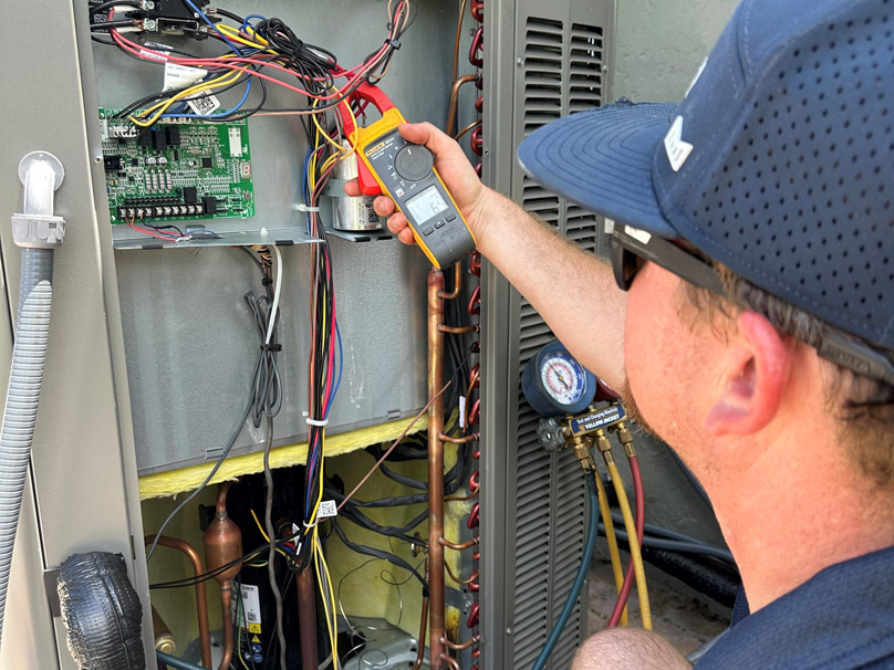 Technician working on heat pump