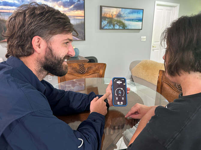 Airtech reviewing smart thermostat with customer