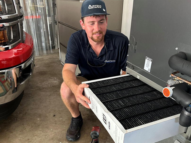 Technician doing air conditioning maintenance