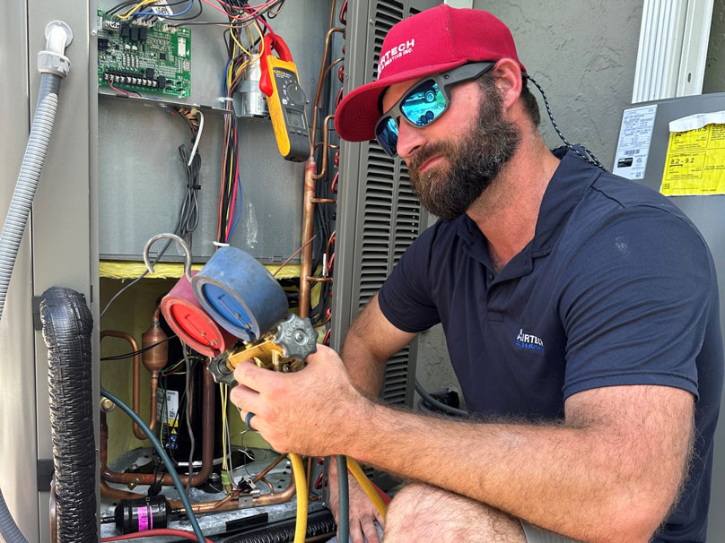 Technician performing air conditioning repair